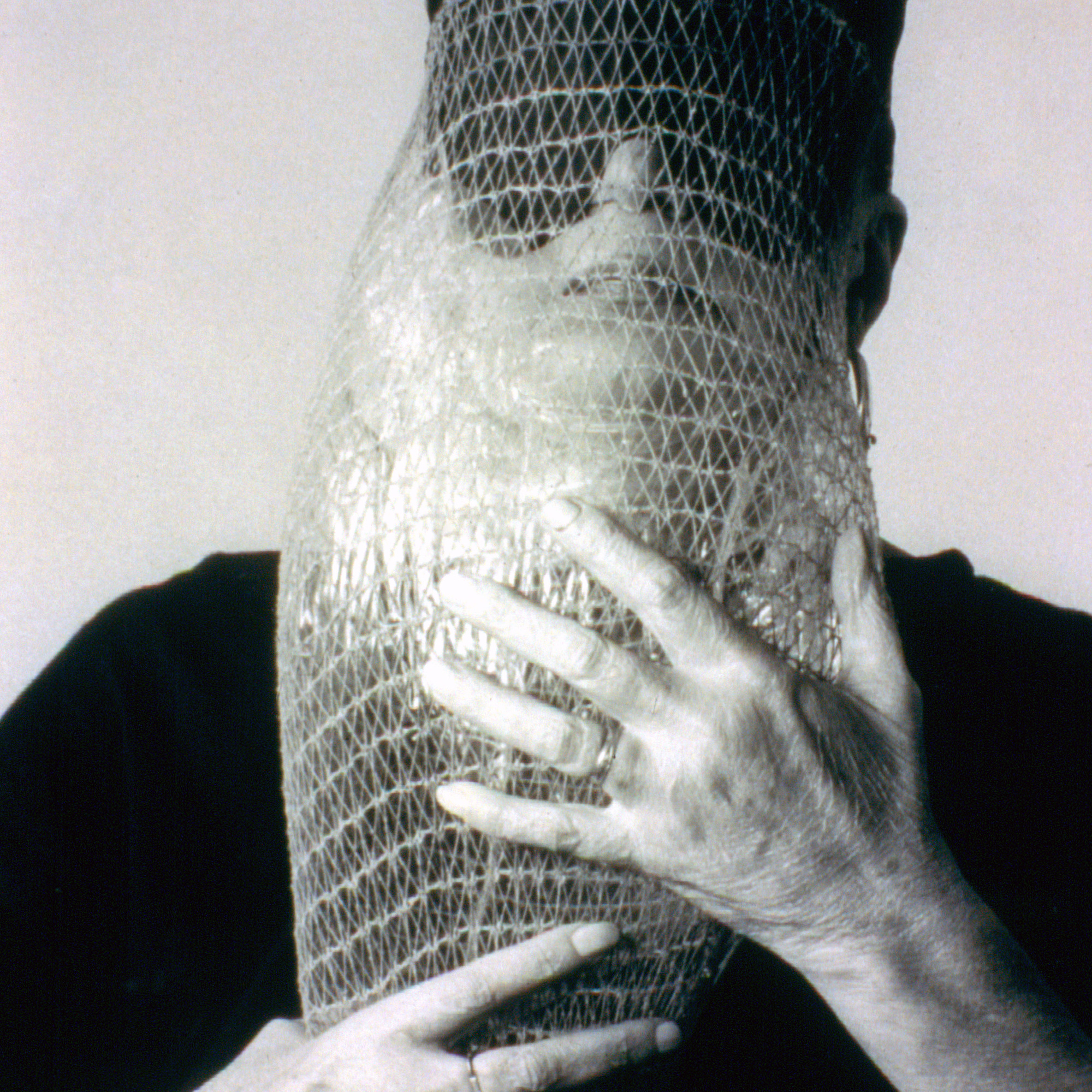 Lygia Clark wearing Máscara abismo com tapa-olhos (Abyssal mask with eye-patch, 1968), a work made of fabric, elastic bands, a nylon bag, and a stone, in use. Courtesy Associação Cultural “O Mundo de Lygia Clark,” Rio de Janeiro. Photo: Sergio Gerardo Zalis, 1986