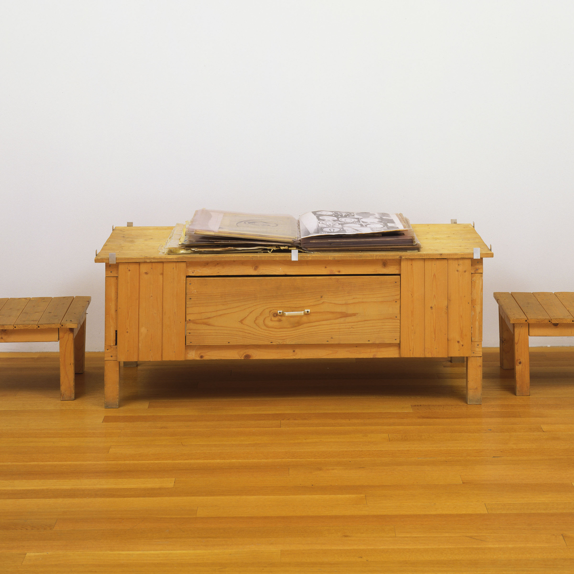 Dieter Roth. Snow. 1964/69. Artist’s book of mixed mediums, with wood table and two wood chairs. Book (closed) 4 × 18 × 20″ (10.2 × 45.7 × 50.8 cm) (irregular), collages, each 20 × 18″ (50.8 × 45.7 cm), commode 22 5/8 × 58 3/4 × 25 7/8″ (57 × 149 × 65.8 cm), chairs, each 24 1/8 × 17 3/4 × 18 1/2″ (61 × 45.1 × 47 cm). The Museum of Modern Art, New York. Committee on Painting and Sculpture Funds, 1998. © 2013 Estate of Dieter Roth