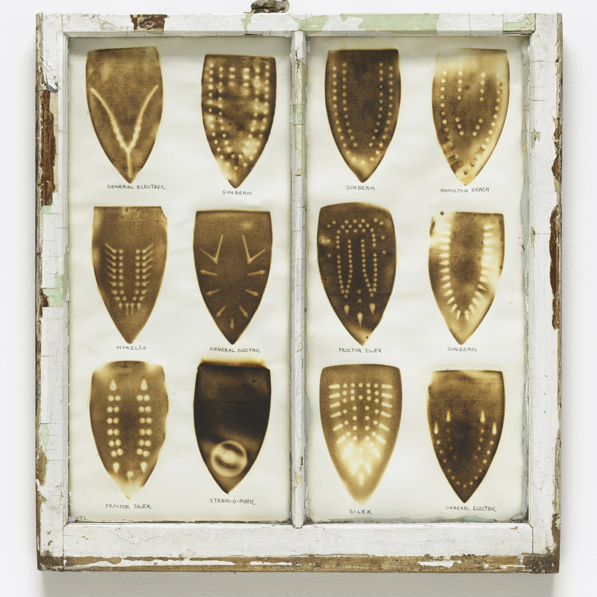 Willie Cole. Domestic I.D. IV. 1992. Iron scorches and pencil on paper mounted in recycled painted wooden window frame, 35 × 32 × 1 1/8″ (88.9 × 81.3 × 3.4 cm). The Museum of Modern Art, New York. Purchased with funds given by Agnes Gund