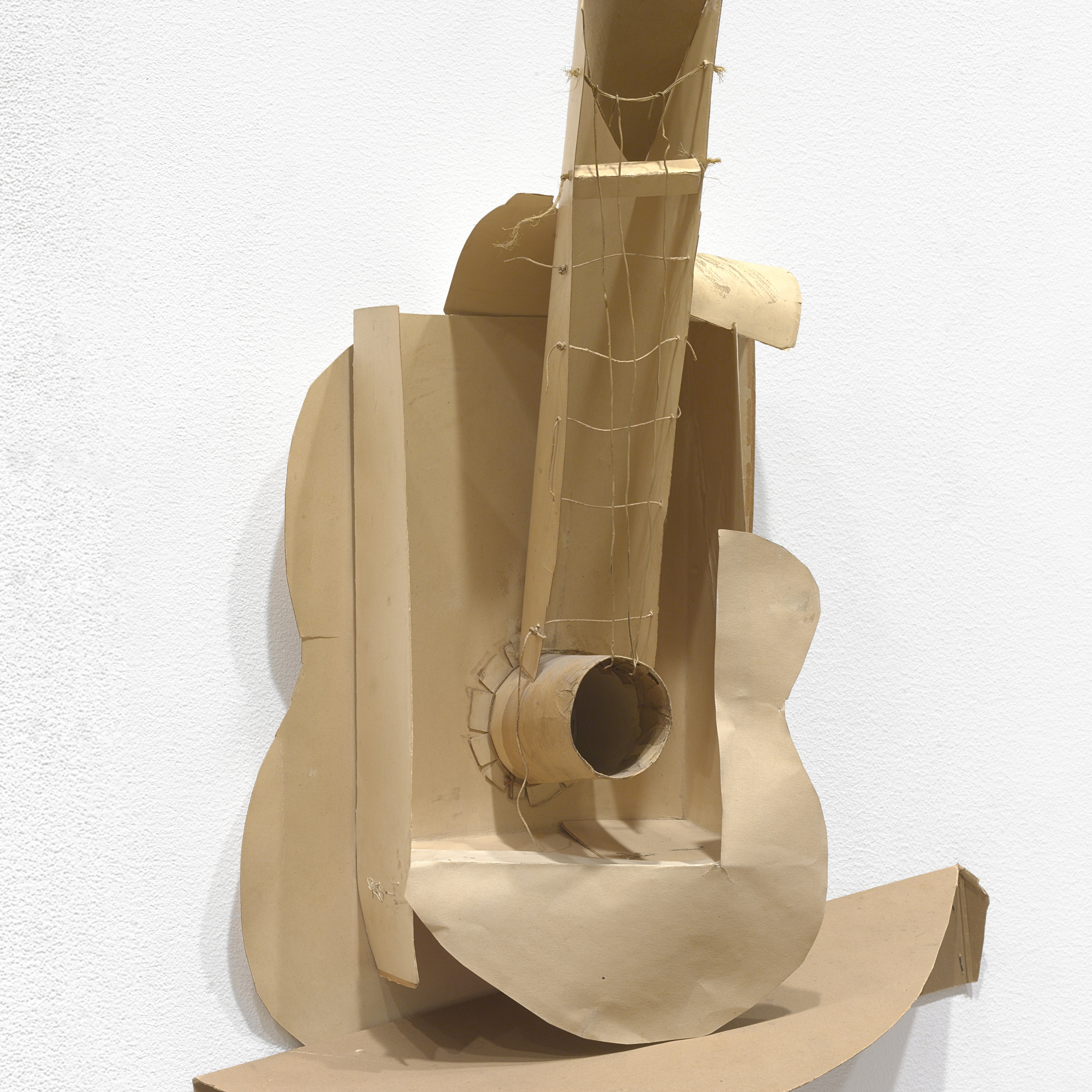 Pablo Picasso. Still life with Guitar. Variant state. Paris, assembled before November 15, 1913. Subsequently preserved by the artist. Paperboard, paper, string, and painted wire installed with cut cardboard box, Overall: 30 × 20 1/2 × 7 3/4″ (76.2 × 52.1 × 19.7cm). The Museum of Modern Art, New York. Gift of the artist. © 2016 Estate of Pablo Picasso / Artists Rights Society (ARS), New York