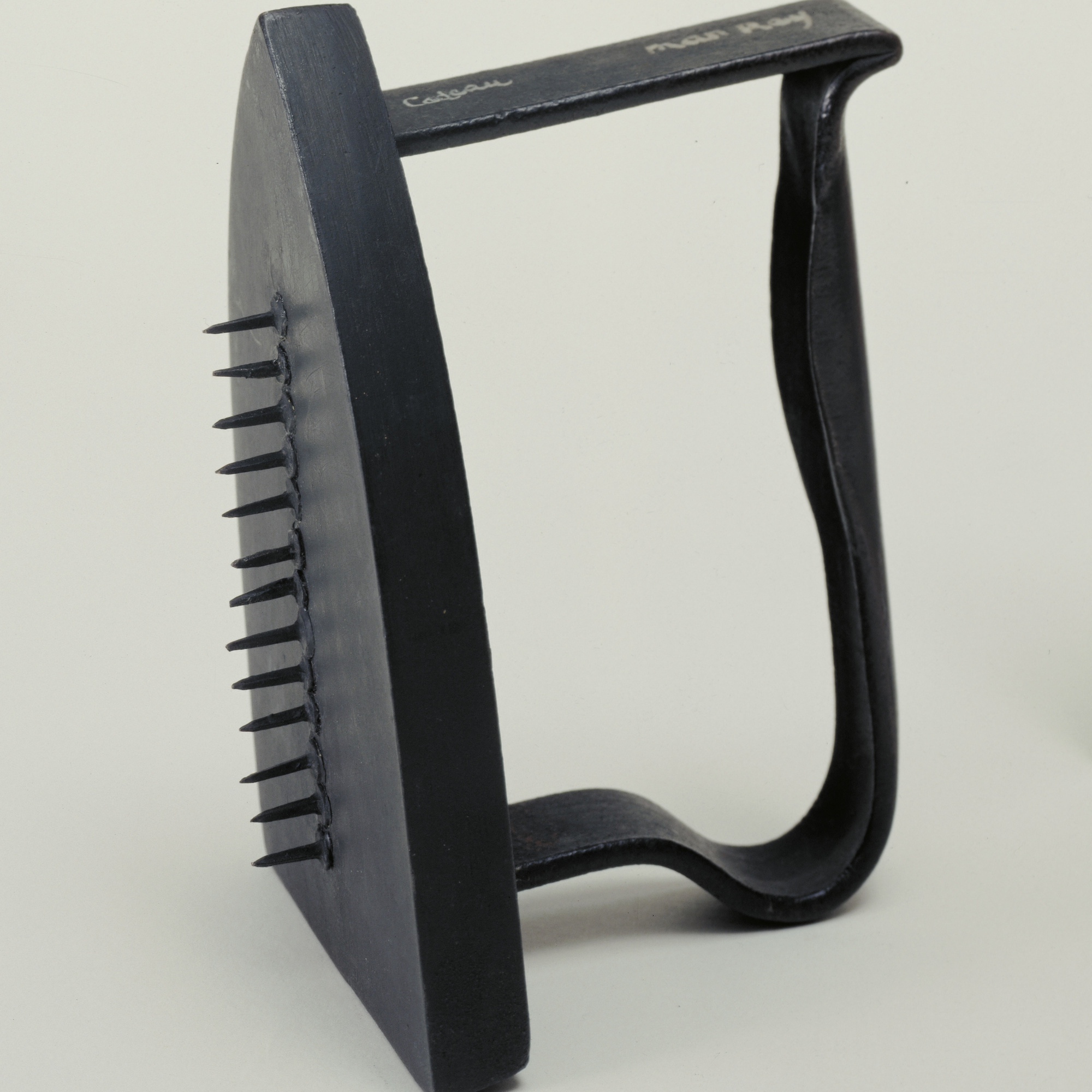 Man Ray. Gift. 1958; replica of 1921 original. Painted flatiron with row of thirteen tacks, heads glued to the irons bottom, 6 1/8 × 3 5/8 × 4 1/2″ (15.3 × 9 × 11.4 cm). James Thrall Soby Fund. © 2016 Man Ray Trust / Artists Rights Society (ARS), New York / ADAGP, Paris