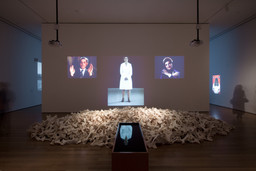 Installation view of Marina Abramović’s Balkan Baroque, The Museum of Modern Art, 2010. Photo by Jason Mandella. Balkan Baroque was originally performed in 1997 for four days, six hours each day at the 47th Venice Biennale. Three-channel video (color, sound), copper sinks and tub filled with black water, bucket, soap, metal brush, dress stained with blood. 24:47 min. © 2010 Marina Abramović. Courtesy the artist and Sean Kelly Gallery/Artists Rights Society (ARS), New York