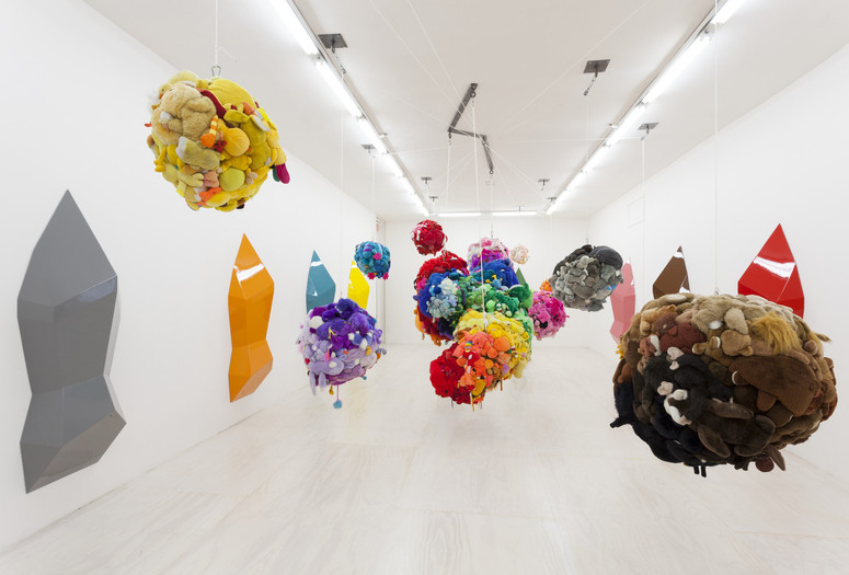 Mike Kelley. Deodorized Central Mass with Satellites. 1991/1999. Plush toys sewn over wood and wire frames with styrofoam packing material, nylon rope, pulleys, steel hardware and hanging plates, fiberglass, car paint, and disinfectant. overall dimensions variable. The Museum of Modern Art, New York. Partial gift of Peter M. Brant, courtesy the Brant Foundation, Inc. and gift of The Sidney and Harriet Janis Collection (by exchange), Mary Sisler Bequest (by exchange), Mr. and Mrs. Eli Wallach (by exchange), The Jill and Peter Kraus Endowed Fund for Contemporary Acquisitions, Anne and Joel Ehrenkranz, Mimi Haas, Ninah and Michael Lynne, and Maja Oeri and Hans Bodenmann