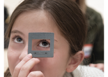 Photo: Martin SeckImage description: A child looks up through a viewfinder