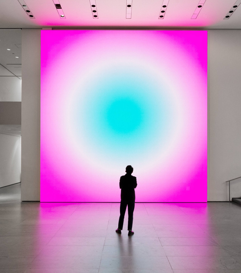 Rafaël Rozendaal standing with his work in the exhibition Light: Rafaël Rozendaal