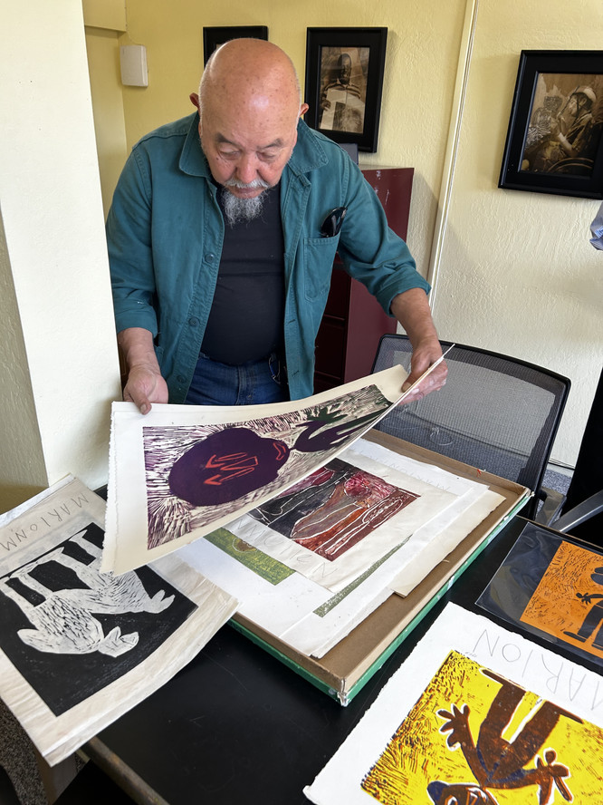 Andrés Cisneros-Galindo with a portfolio of the artist’s early works on paper. Courtesy NIAD Art Center