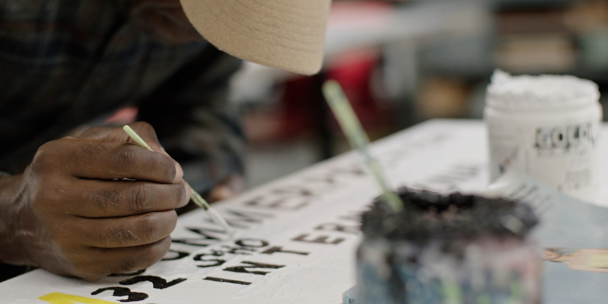 Marlon Mullen working on a painting at NIAD Art Center
