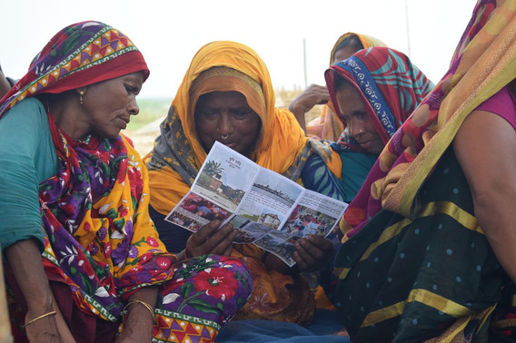Women reading a Khudi Bari pamphlet produced by Marina Tabassum Architects for the project’s community engagement component, 2021