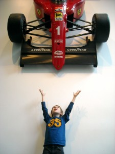 DSCN0364 Ethan is delighted by the Formula 1 Racing Car hanging in the Education and Research building lobby.