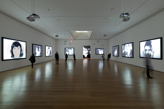 Installation view of Andy Warhol: Motion Pictures at The Museum of Modern Art, 2010. Left to right, Screen Test: Susan Sontag (1964), Screen Test: Dennis Hopper (1964), Screen Test: Kathe Dees (1964), Screen Test: Edie Sedgwick (1965), Kiss (1963-64), Screen Test: Lou Reed (1966), Screen Test: Kyoko Kishida (1964), Screen Test: Baby Jane Holzer (1964), and Screen Test: Donyale Luna (1964). © 2010 The Andy Warhol Museum, Pittsburgh, PA, a museum of Carnegie Institute. All rights reserved. Photo: Jason Mandella