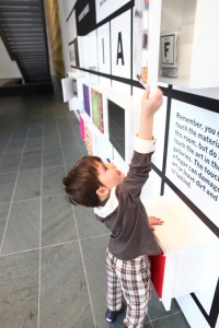 A visitor looks inside a discovery box in Material Lab. Photo by Michael Nagle