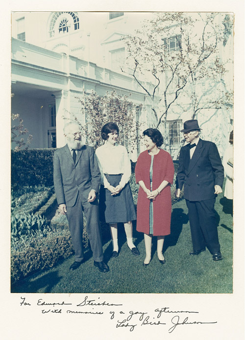 Unknown White House photographer. For Edward Steichen with memories of a gay afternoon, Lady Bird Johnson. From left, Edward Steichen, Lynda Bird Johnson, First Lady Claudia Taylor (Lady Bird) Johnson, Carl Sandburg. Rose Garden, The White House, Washington, District of Columbia, (April 10, 1964). Chromogenic color print. Edward Steichen Archive, VIII. The Museum of Modern Art Archives, New York