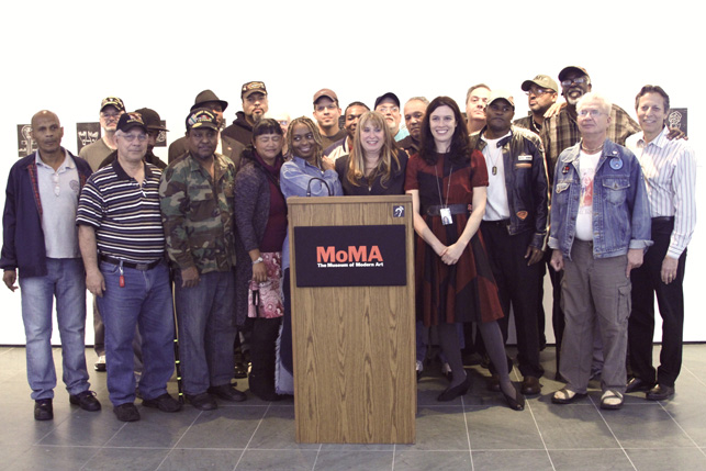 Participants in the exhibition and Veterans Support Center staff join MoMA educator Sally Paul.