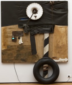 Robert Rauschenberg, <em>First Landing Jump</em> 1961. Cloth, metal, leather, electric fixture, cable, and oil paint on composition board, with automobile tire and wood plank. Gift of Philip Johnson Robert Rauschenberg, <em>First Landing Jump</em> 1961. Cloth, metal, leather, electric fixture, cable, and oil paint on composition board, with automobile tire and wood plank, 7' 5 1/8" x 6' x 8 7/8" (226.3 x 182.8 x 22.5 cm). Gift of Philip Johnson