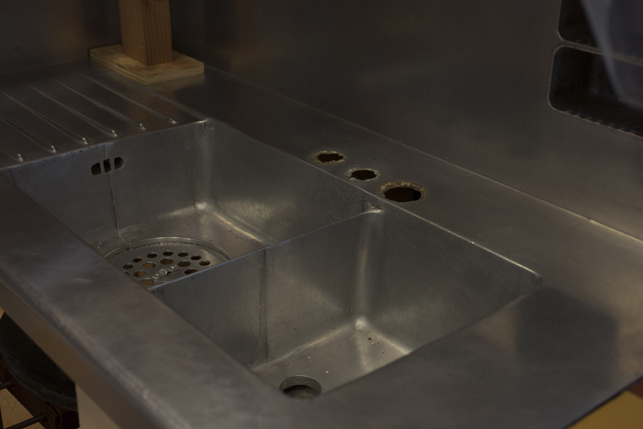 Detail of the holes where the original faucet was located. The hot and cold water taps and spout were separate in the original fixture.