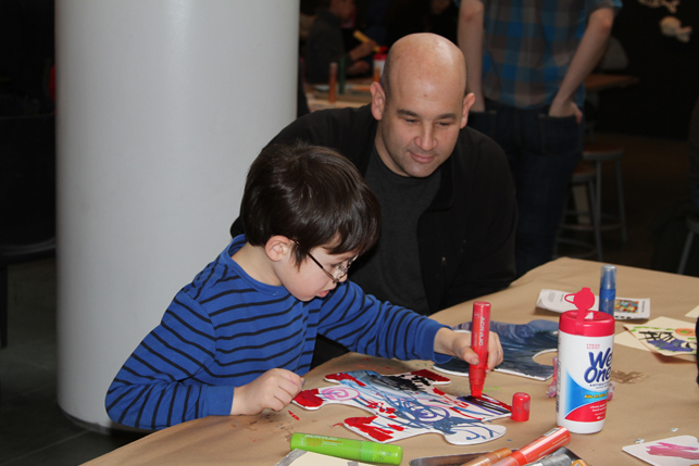 A father and son working on their piece