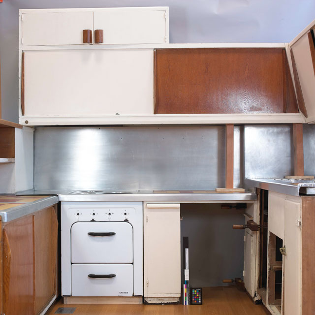 6. The large sliding door over the stove before the over paint was removed.