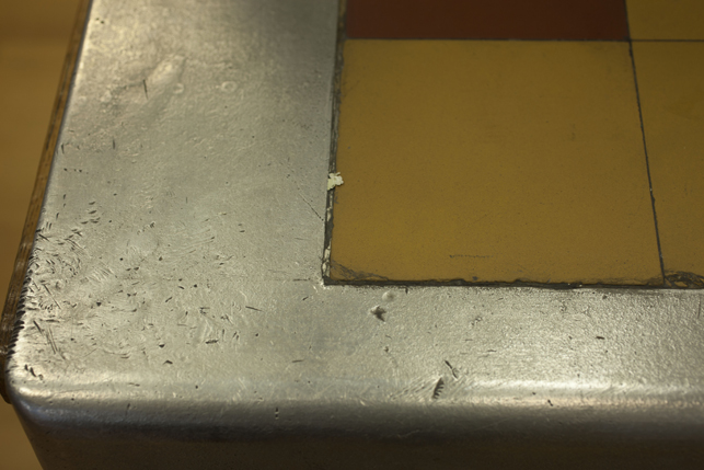A detail of the surface of the cast aluminum countertop. The uneven surface is a result of the casting process. A detail of the surface of the cast aluminum countertop. The uneven surface is a result of the casting process.