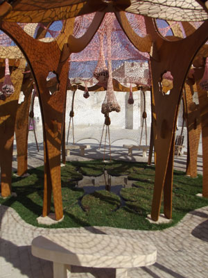 Ernesto Neto. Enquanto a cultura nos separa, a natureza nos une (While Culture Moves Us Apart, Nature Brings Us Together.) 2013. Crochet with polyester rope, ice, stones, plywood, grass, fiberglass, water, clay and wood connectors, and loam. Installation view, Sharjah Biennial 11, Re:emerge: Towards a New Cultural Cartography, March 13– May 13, 2013. Commissioned by Sharjah Art Foundation