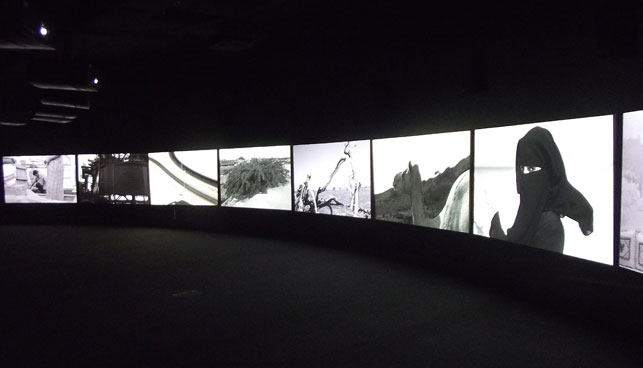 Yang Fudong. Push the door softly and walk in, Or just stay standing where you are. 2013. Multiscreen video installation. Installation view, Sharjah Biennial 11, Re:emerge: Towards a New Cultural Cartography, March 13– May 13, 2013. Commissioned by Sharjah Art Foundation