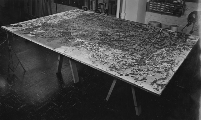 An image of Number 1A undergoing conservation treatment in 1959. The darkness across much of the canvas is soot deposited during the fire. Here, conservators have begun to clean, working from the edges toward the center