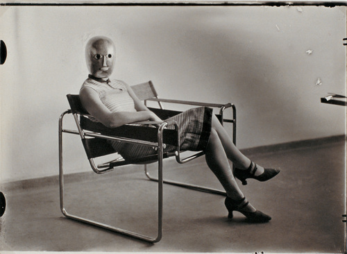 Erich Consem&ouml;ller. Untitled (Woman [Lis Beyer or Ise Gropius] in B3 club chair by Marcel Breuer wearing a mask by Oskar Schlemmer and a dress in fabric designed by Beyer). c. 1926
