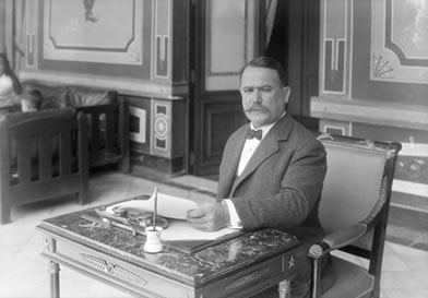Photo of Obregón at writing desk