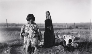 Marie Cow Killer With Doll given by Elaine and Alice Boyle, Petrified Wood and Buffalo Skull,