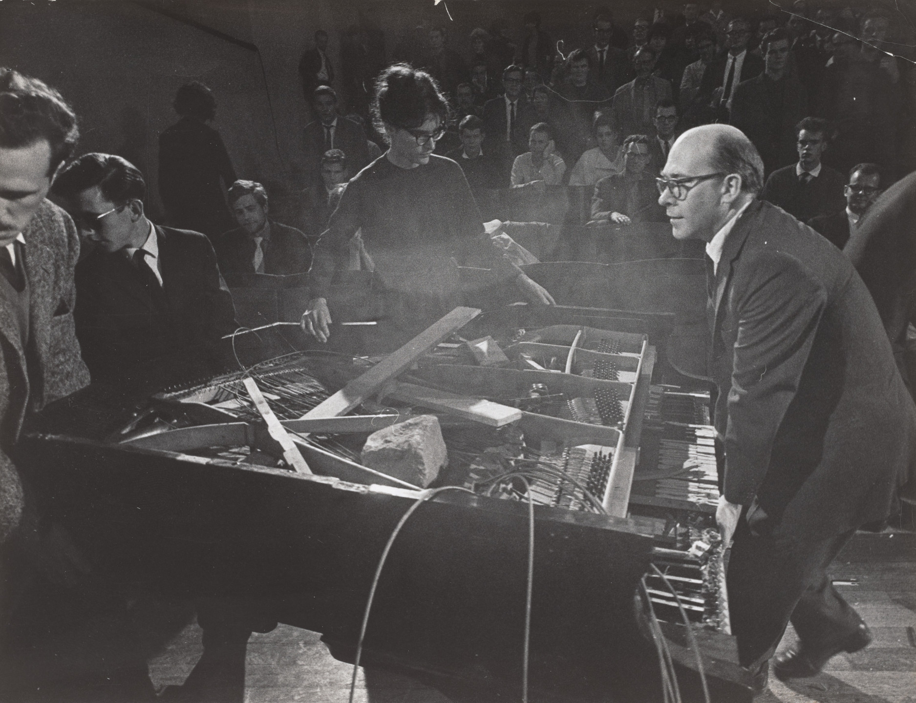 Philip Corner, George Maciunas, Dick Higgins, Emmett Williams, Benjamin Patterson, Alison Knowles. Philip Corner&#39;s Piano Activities, performed by Philip Corner, George Maciunas, Emmett Williams, Benjamin Patterson, Dick Higgins, and Alison Knowles during Fluxus Internationale Festpiele Neuester Musik, Hörsaal des Städtischen Museums, Wiesbaden, Germany, September 1, 1962. 1962