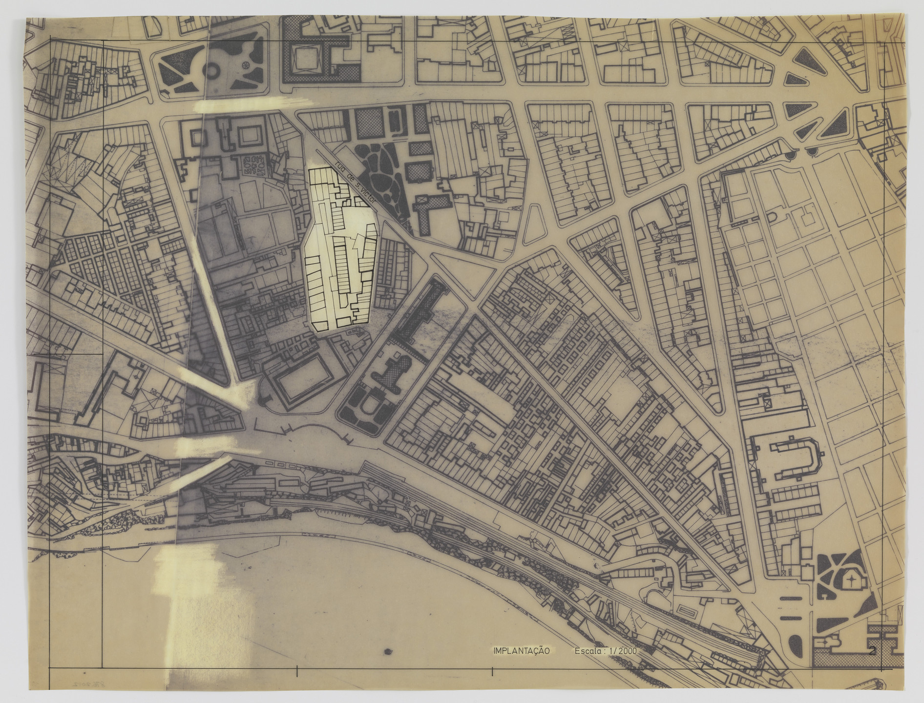 A detailed map with primarily black lines on a tan background displays a densely packed urban area with defined streets and buildings. One large building in the center is highlighted in white. This is an AI generated description. To give feedback, email ai@moma.org.
