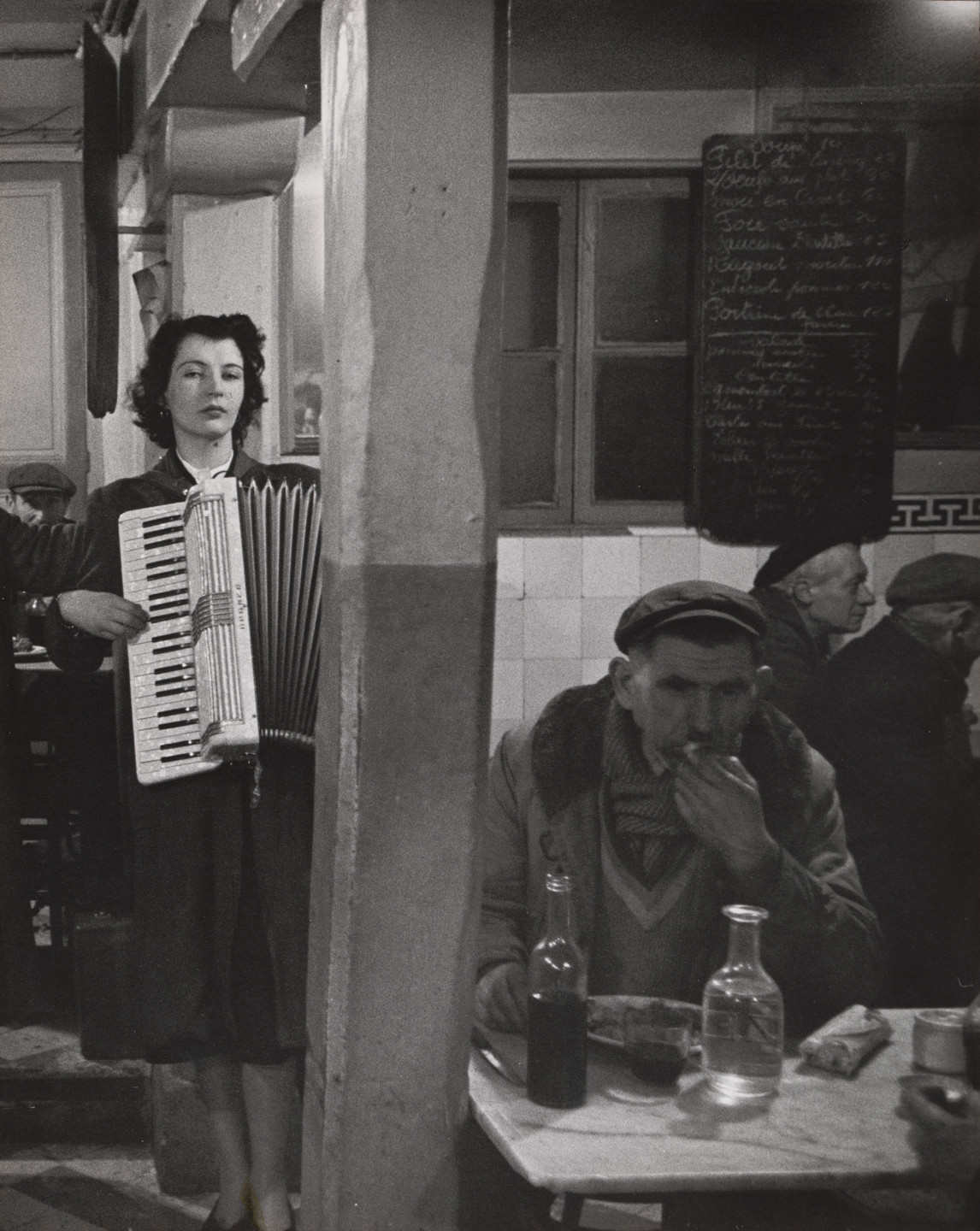 Robert Doisneau. Accordionist Playing in a Bistro near Les Halles, Paris. c. 1950