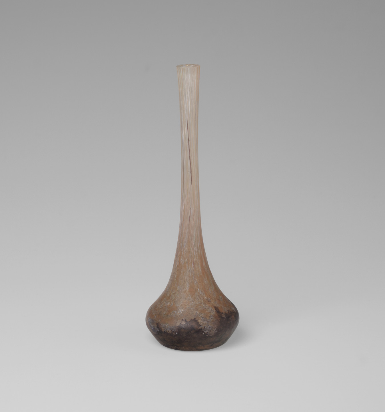 A tall, slender vase with a narrow neck flares out at the bottom. It features a gradient from light to dark brown, with darker shades at the base. This is an AI generated description. To give feedback, email ai@moma.org.