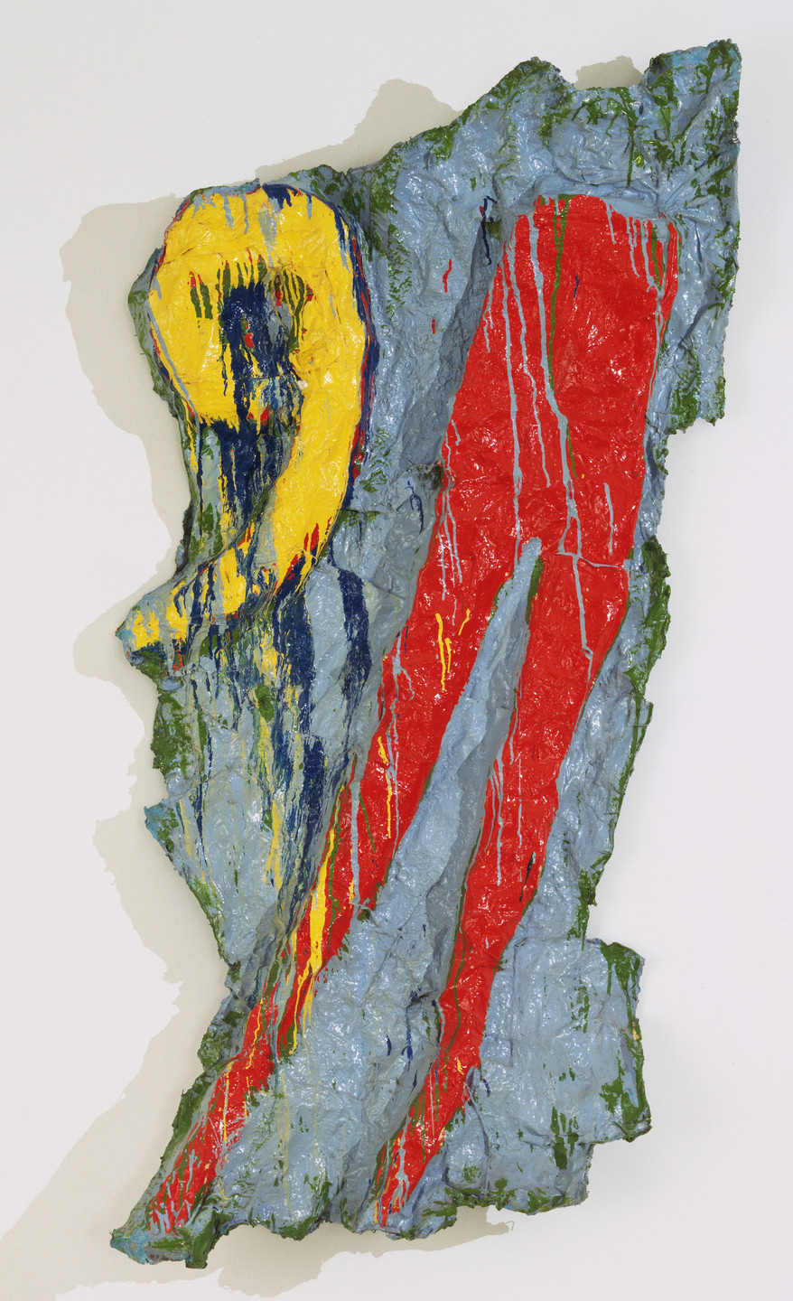 A textured, irregularly-shaped piece of art with predominant colors of blue, red, yellow, and green. The surface has a three-dimensional quality with yellow and red forms on a blue and green background. This is an AI generated description. To give feedback, email ai@moma.org.
