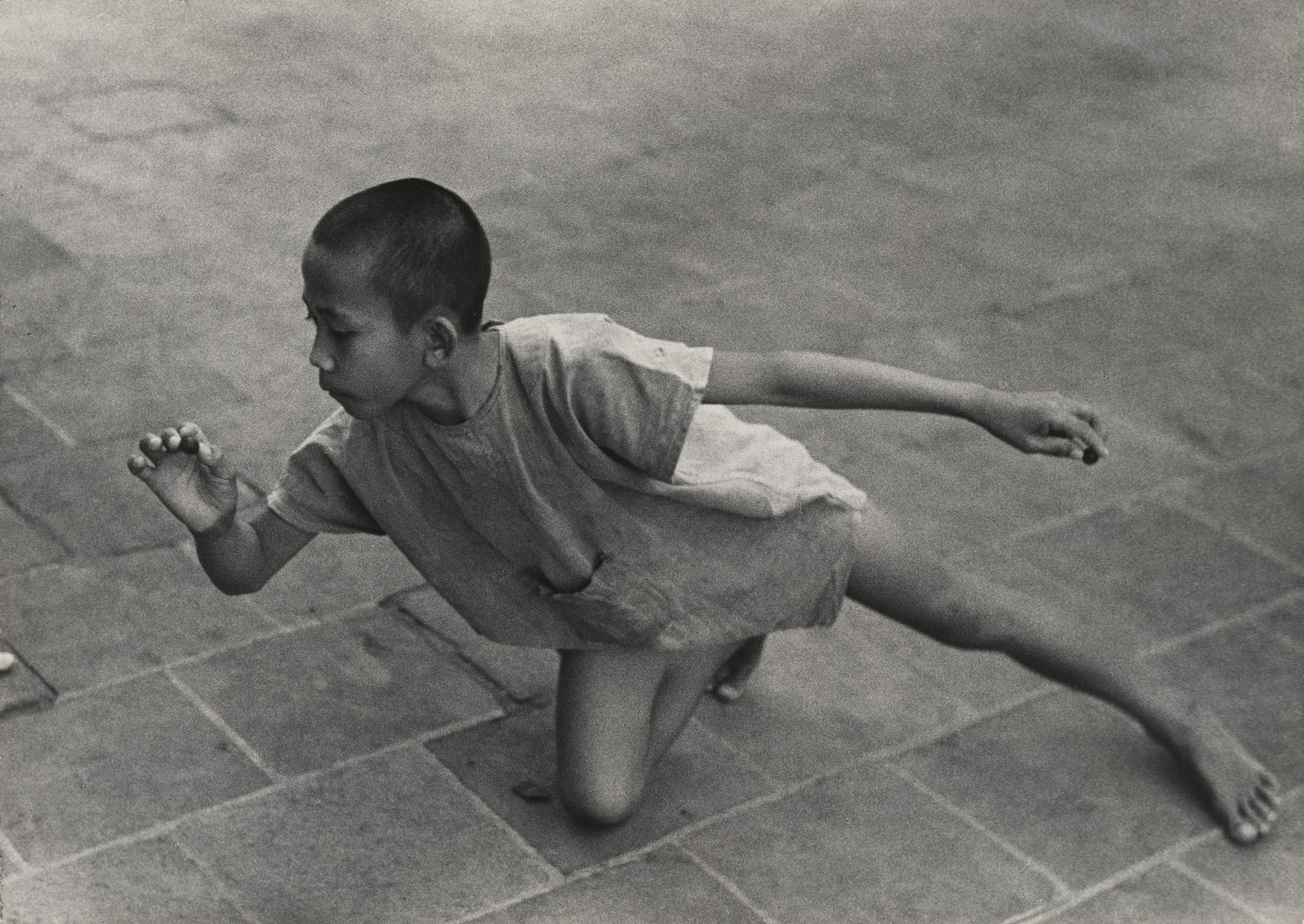 Gotthard Schuh. Boy Playing Marbles, Java. 1938