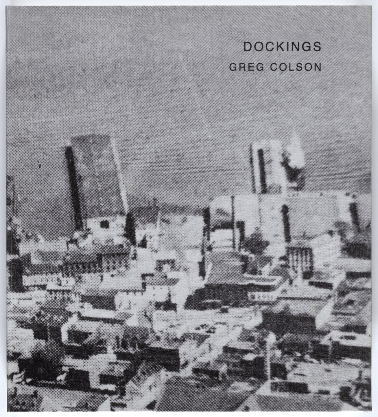 A grayscale image shows an urban landscape with various buildings of different shapes and sizes. The text &#34;DOCKINGS&#34; and &#34;GREG COLSON&#34; appears in the upper right corner. This is an AI generated description. To give feedback, email ai@moma.org.