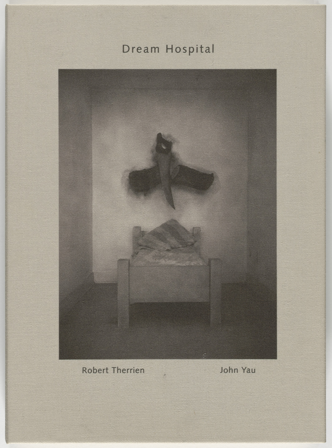 A grayscale image depicts a bed in a plain room with an item resembling a large knife crossed with bent wings on the wall above the bed. The words &#34;Dream Hospital&#34; are centered above the image. This is an AI generated description. To give feedback, email ai@moma.org.