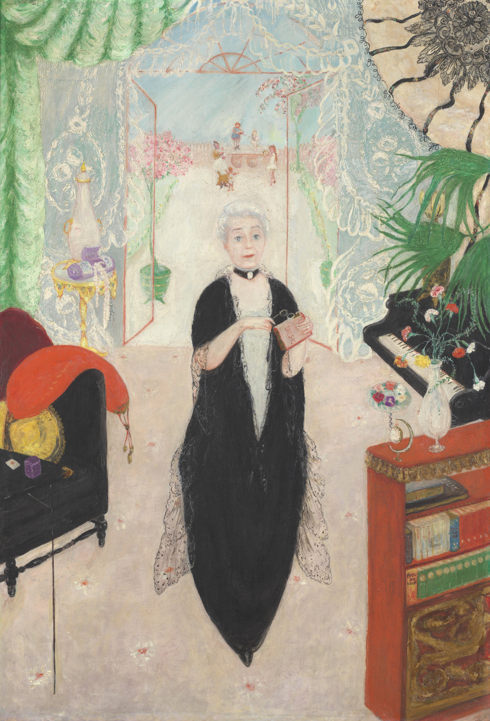 A person with white hair in a long black outfit stands in an ornate room with green drapes, beside a yellow table and a black piano. Colorful flowers and books decorate the space. This is an AI generated description. To give feedback, email ai@moma.org.
