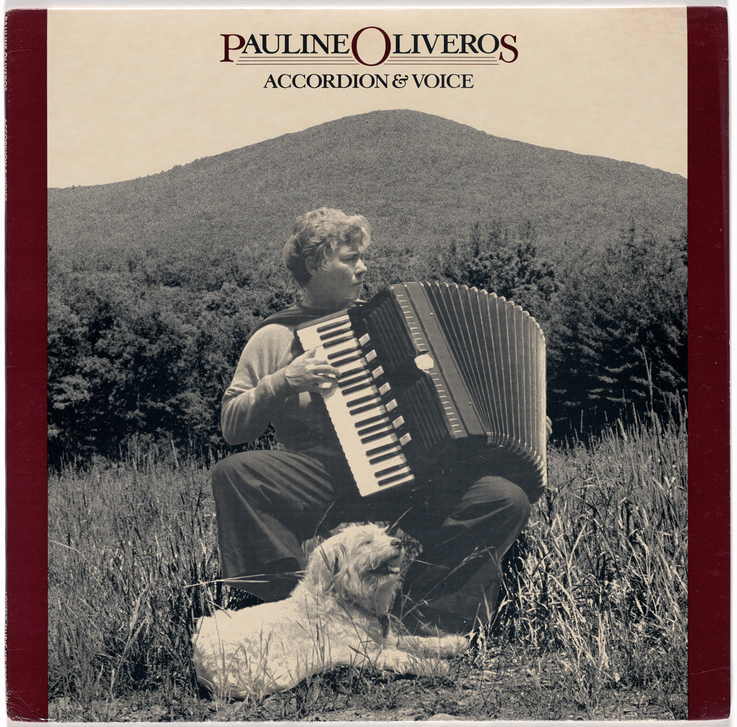 A person is seated on the grass playing an accordion, with a dog lying beside them. The background features trees and a large mountain under a beige sky. This is an AI generated description. To give feedback, email ai@moma.org.