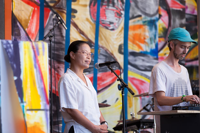Terreke greets the early afternoon crowd with some guidance from Dr. Ven. Chung Ohun Lee. MoMA PS1 Warm Up, Saturday, 24, 2013. Photo: Zachary Newton