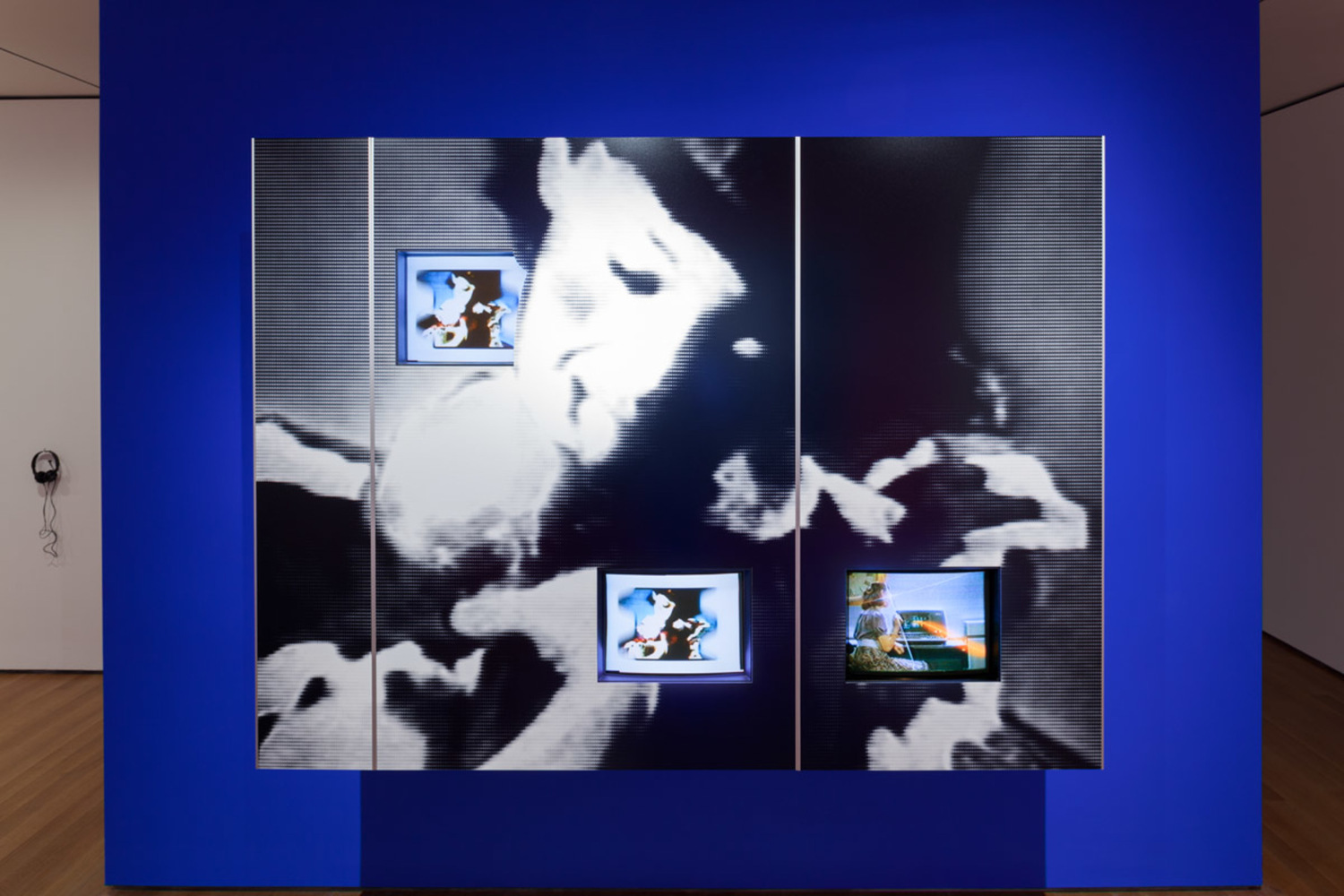 Dara Birnbaum. PM Magazine (detail). 1982. Four-channel video (color, three channels of stereo sound, 6:30 min.), two chromogenic prints, Speed Rail® structural support system, aluminum trim, one wall painted Chroma Key Blue, and one wall painted red, dimensions variable. Installation view, Cut to Swipe, The Museum of Modern Art, New York, October 11, 2014–March 22, 2015. The Museum of Modern Art, New York. Acquired with support from The Modern Women's Fund Committee, The Contemporary Arts Council of The Museum of Modern Art, and through the generosity of Ahmet Kocabiyik, 2014. © 2015 Dara Birnbaum. Image courtesy the artist and Marian Goodman Gallery, New York and Paris