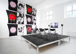 James Richards. Foreground: Active Negative programme. 2008. Video (color, sound). 20 min. Background: Untitled Merchandise (Lovers &amp; Dealers). 2012. Six machine-knitted nylon blankets. 152 x 228 cm. Installation view from The Imaginary Museum, Kunstverein Munich, 2012. Courtesy the artist and Rodeo, Istanbul and London and Cabinet, London