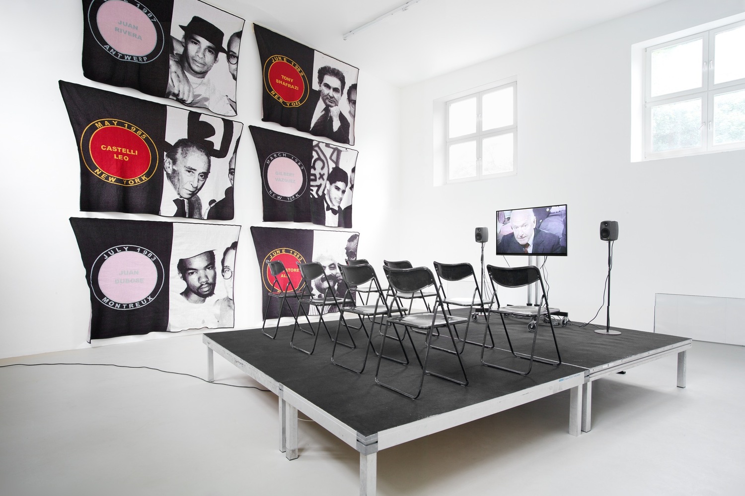 James Richards. Foreground: Active Negative programme. 2008. Video (color, sound). 20 min. Background: Untitled Merchandise (Lovers & Dealers). 2012. Six machine-knitted nylon blankets. 152 x 228 cm. Installation view from The Imaginary Museum, Kunstverein Munich, 2012. Courtesy the artist and Rodeo, Istanbul and London and Cabinet, London