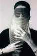 Lygia Clark wearing Máscara abismo com tapa-olhos (Abyssal mask with eye-patch, 1968), a work made of fabric, elastic bands, a nylon bag, and a stone, in use. Courtesy Associação Cultural “O Mundo de Lygia Clark,” Rio de Janeiro. Photo: Sergio Gerardo Zalis, 1986