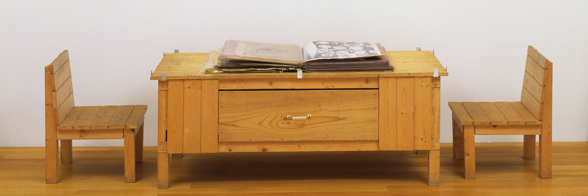 Dieter Roth. Snow. 1964/69. Artist’s book of mixed mediums, with wood table and two wood chairs. Book (closed) 4 × 18 × 20″ (10.2 × 45.7 × 50.8 cm) (irregular), collages, each 20 × 18″ (50.8 × 45.7 cm), commode 22 5/8 × 58 3/4 × 25 7/8″ (57 × 149 × 65.8 cm), chairs, each 24 1/8 × 17 3/4 × 18 1/2″ (61 × 45.1 × 47 cm). The Museum of Modern Art, New York. Committee on Painting and Sculpture Funds, 1998. © 2013 Estate of Dieter Roth