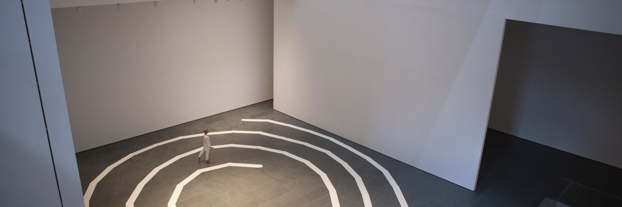 Performance of James Lee Byars’s The Mile-Long Paper Walk (1965–2014) at The Museum of Modern Art, August 17, 2014. Performed by Katie Dorn; choreographic construction by Lucinda Childs. © 2014 Museum of Modern Art, New York. Photo by Julieta Cervantes