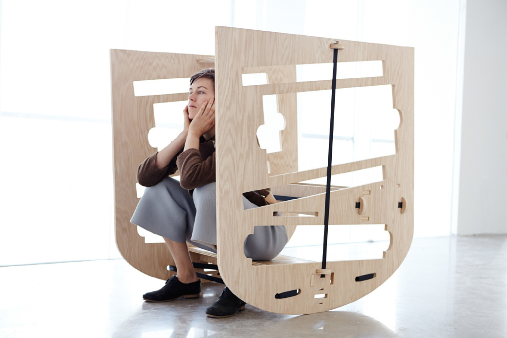 Caroline Woolard. Queer Rocker. 2013. CNC prototype, oak plywood, rachet straps, newspapers, 48 x 30 x 44”. Courtesy of the artist