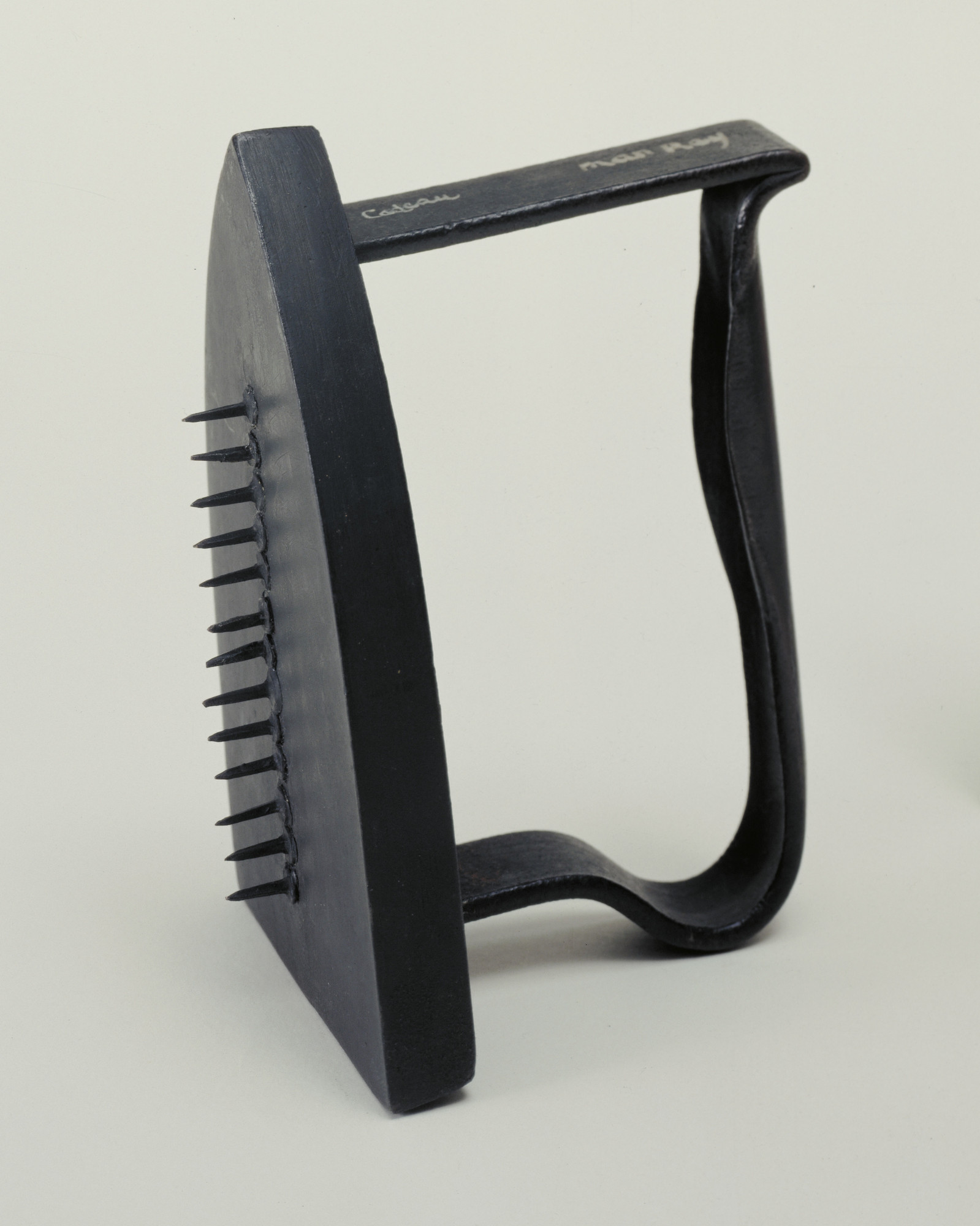 Man Ray. Gift. 1958; replica of 1921 original. Painted flatiron with row of thirteen tacks, heads glued to the irons bottom, 6 1⁄8 × 3 5⁄8 × 4 1/2″ (15.3 × 9 × 11.4 cm). James Thrall Soby Fund. © 2016 Man Ray Trust / Artists Rights Society (ARS), New York / ADAGP, Paris