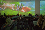 Pipilotti Rist. Pour Your Body Out (7354 Cubic Meters). 2008. Multichannel video projection (color, sound), projector enclosures, circular seating element, carpet. Installation view at The Museum of Modern Art, 2008. Photo: Thomas Griesel