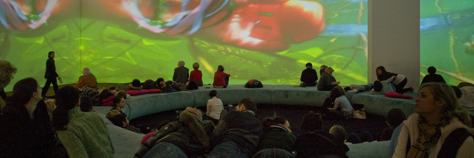 Pipilotti Rist. Pour Your Body Out (7354 Cubic Meters). 2008. Multichannel video projection (color, sound), projector enclosures, circular seating element, carpet. Installation view at The Museum of Modern Art, 2008. Photo: Thomas Griesel
