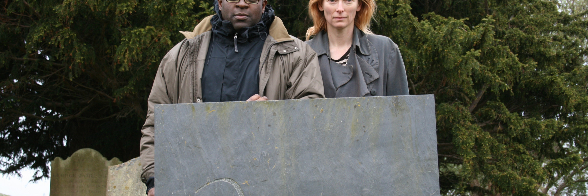 Isaac Julien and Tilda Swinton at Derek Jarman’s grave, Old Romney, Kent, 2008, during the making of Derek (2008). Photo: by Nina Kellgren. Courtesy Isaac Julien